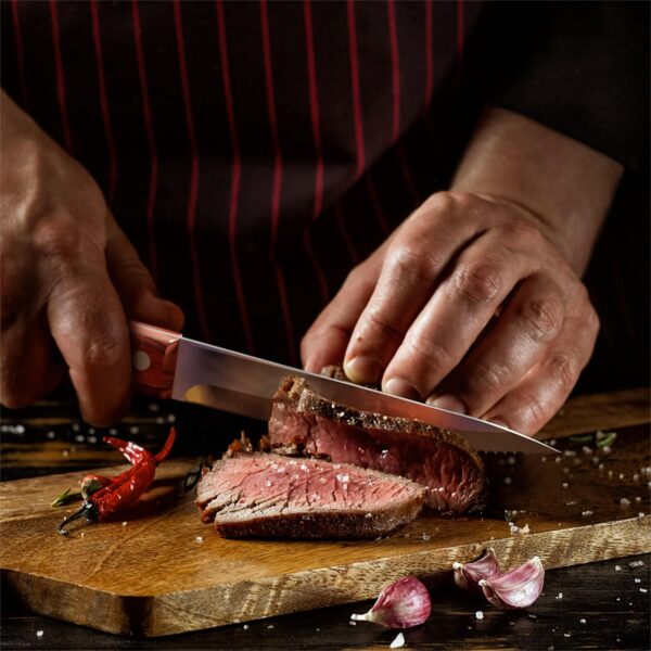 Chef slicing steak with sharp steak knife