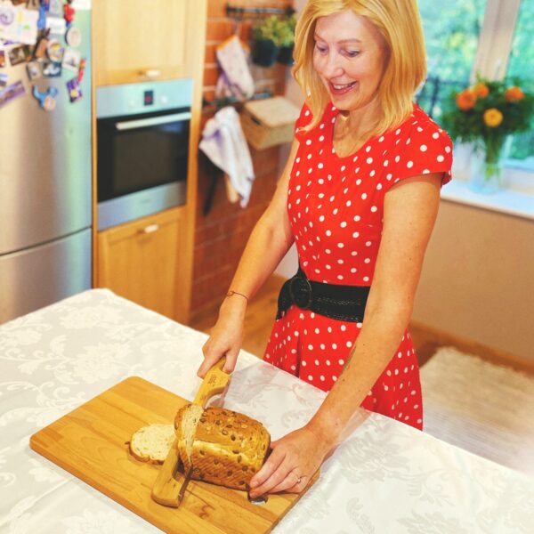 Woman Slicing Bread with Bread Bow Knife
